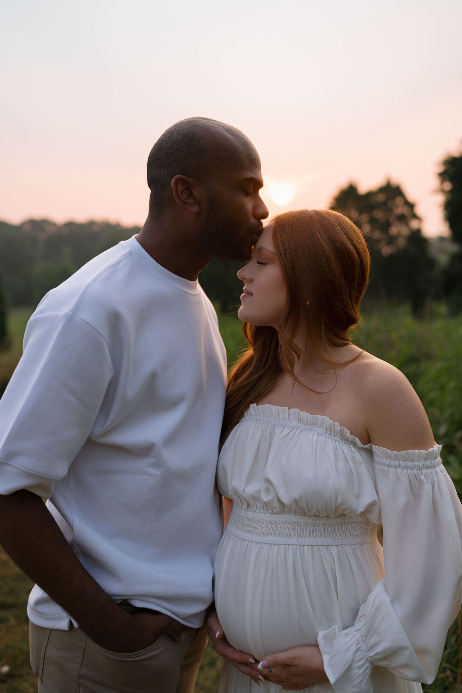 Couple celebrating their growing family during a maternity session at Highlands Prairie.