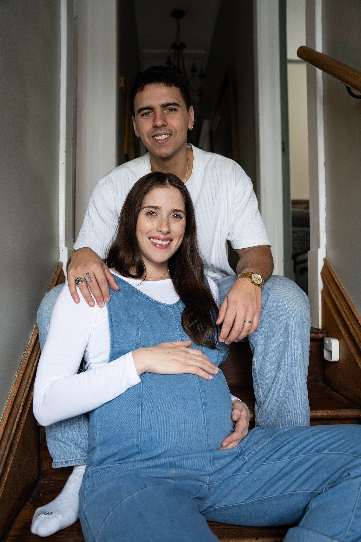 Expectant parents sharing a joyful moment together inside a private estate in Allendale.