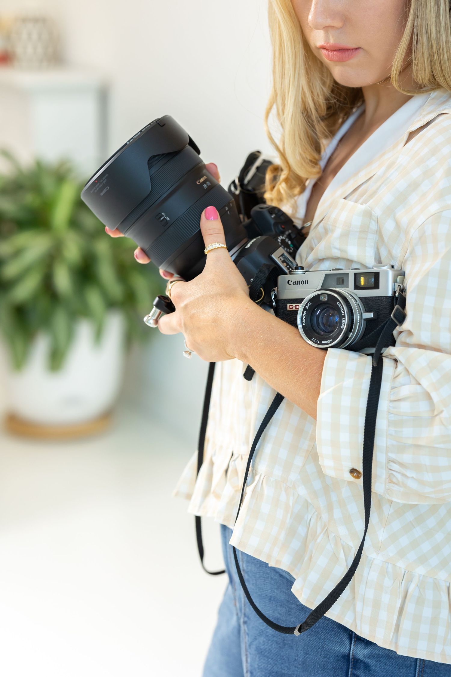 Rock Hill Wedding Photographer holding two cameras to show what equipment is good to use at a wedding.