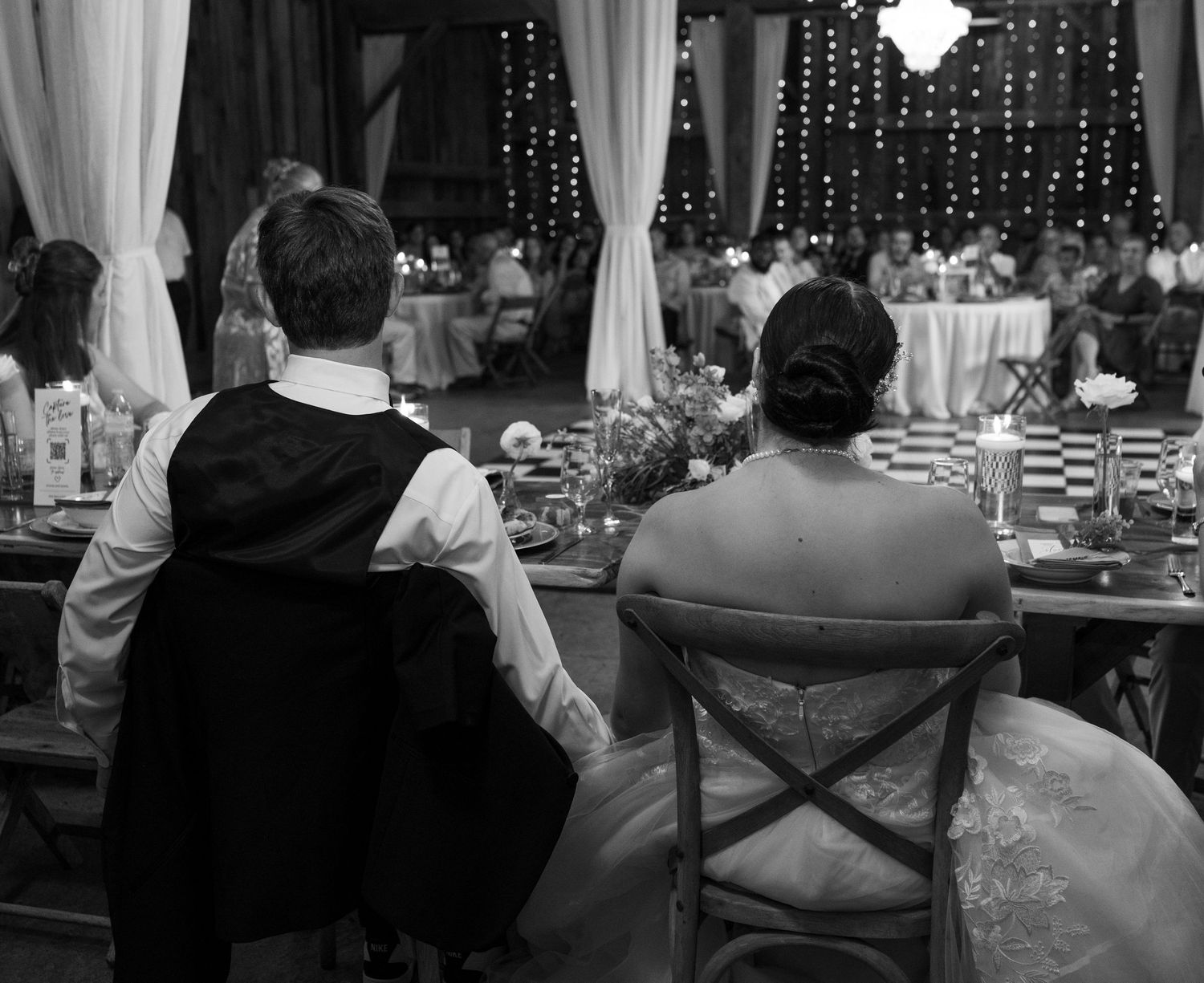 Bride and groom holding hands at dinner. Photo at The Historic Robertson Homestead by Rock Hill Photographer, Natalie Wilson