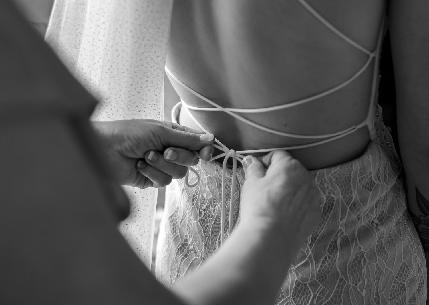 Mother of bride helping bride get dress on, photo taken by Rock Hill Wedding Photographer Natalie Wilson