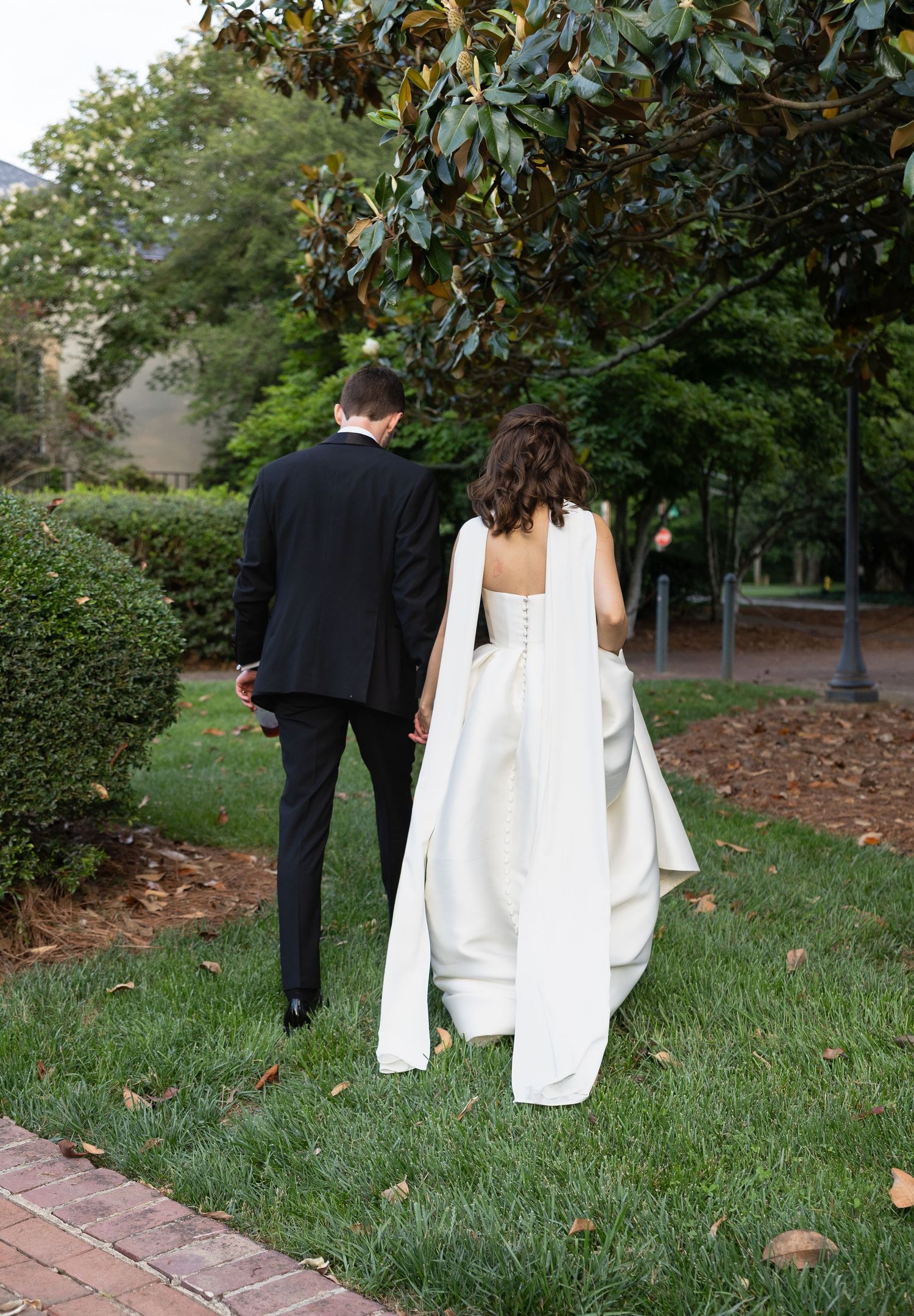 Bride and groom walking at the Mint Museum in Charlotte, photo by Rock Hill Wedding Photographer, Natalie Wilson Photo