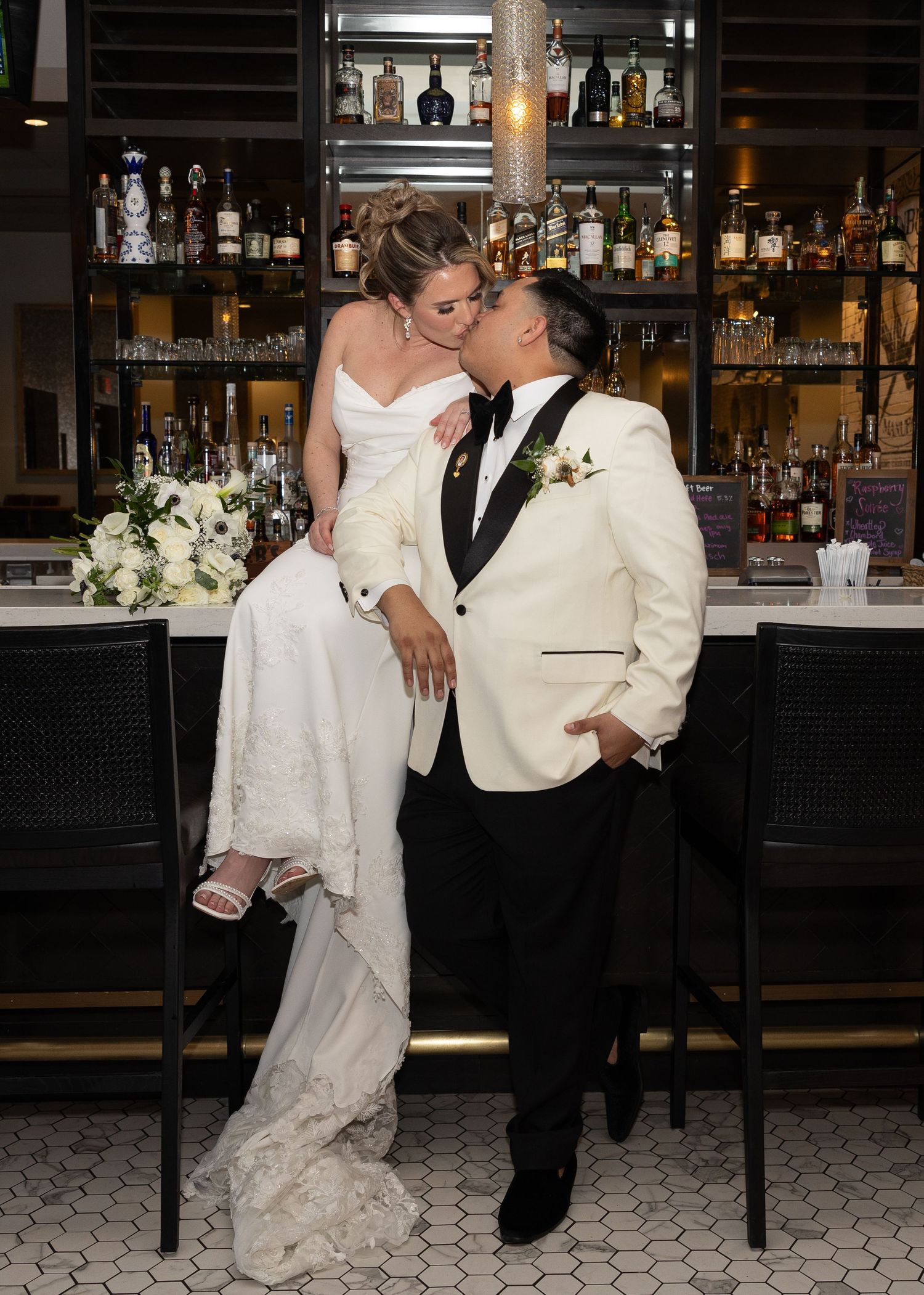 Bride and groom kissing at a bar located at 1881 Event Hall, photo taken by Rock Hill Photographer, Natalie Wilson Photo