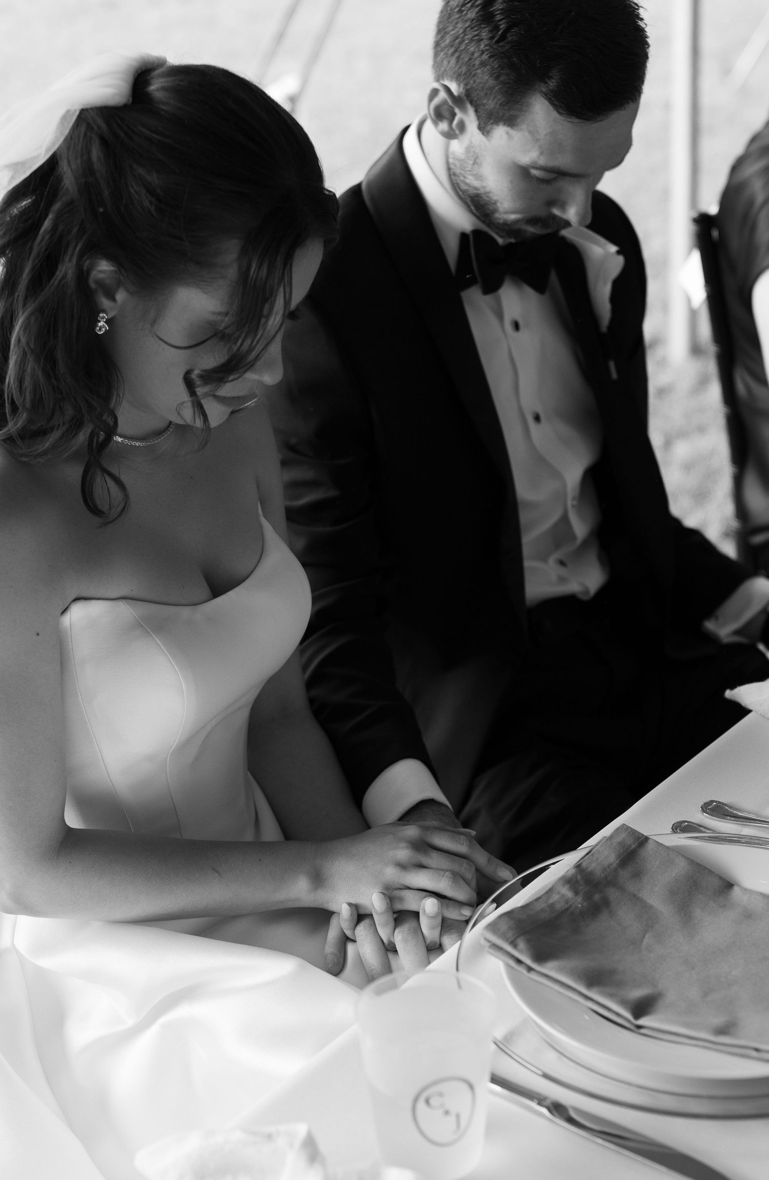 Bride and groom praying over dinner photo by Rock Hill Wedding Photographer, Natalie Wilson Photo