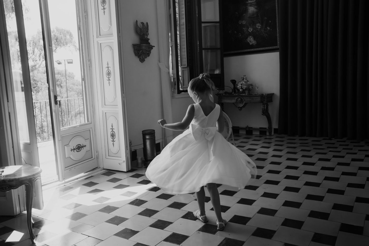 Flower girl twirling in the beautiful bridal suite at Marques de Montemolar, Altea, Alicante, Spain