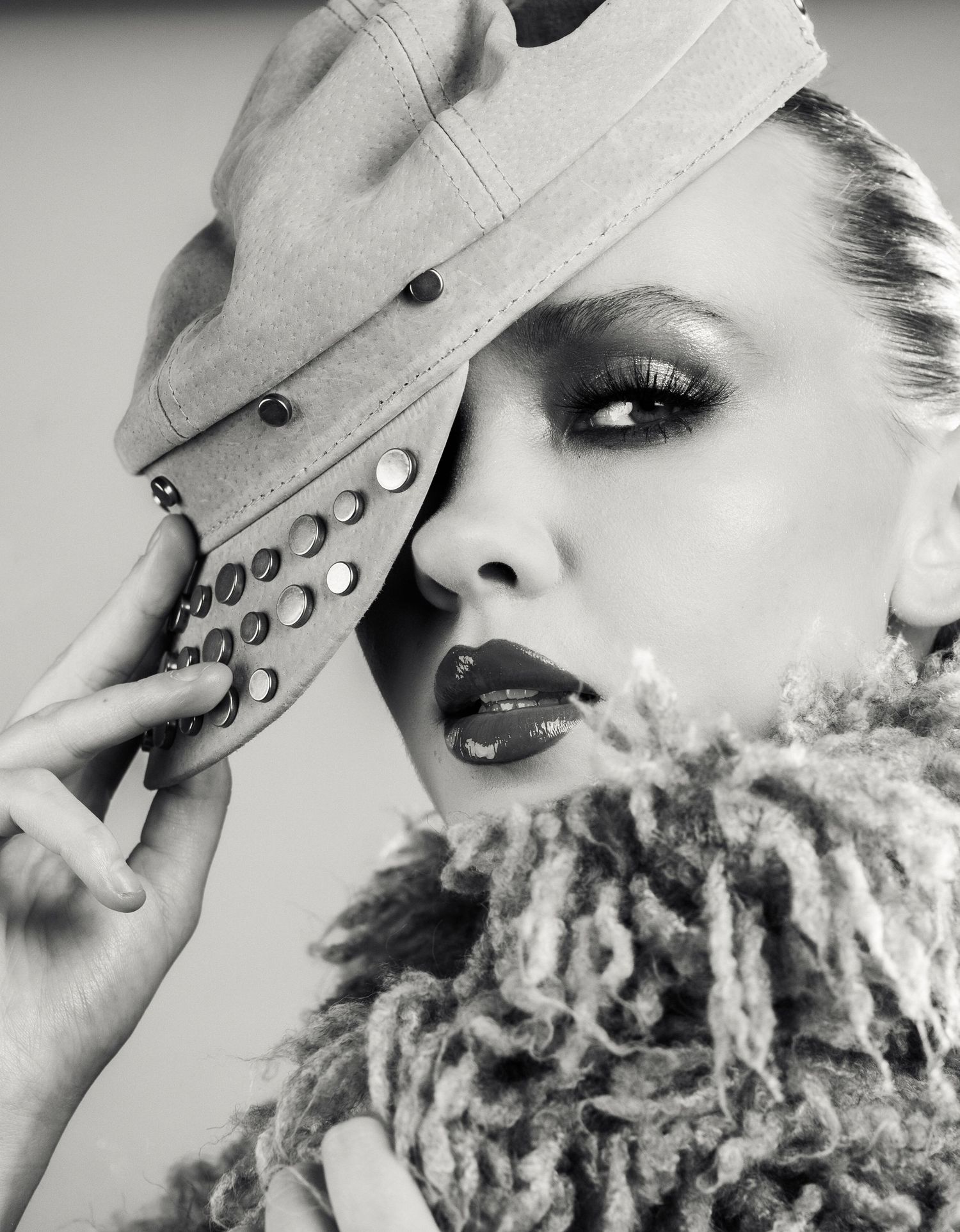 Artistic black and white fashion portrait series showing a person wearing a hat in different dramatic poses.