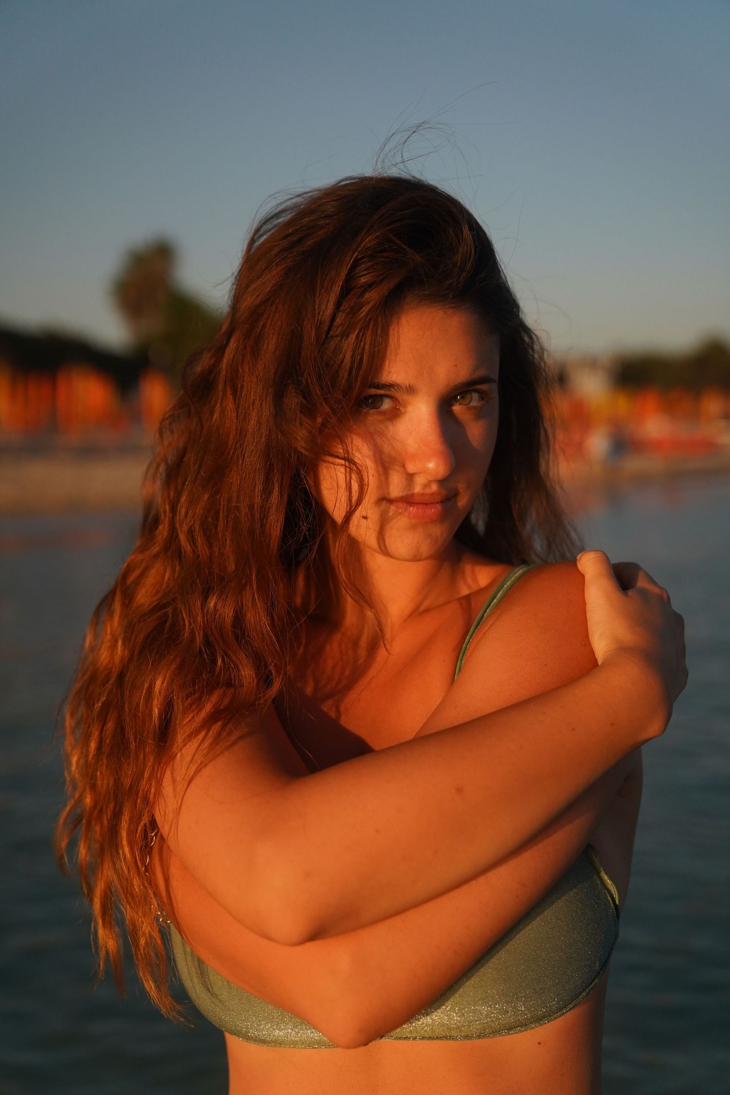 Beach portrait at golden hour with warm sunset lighting.