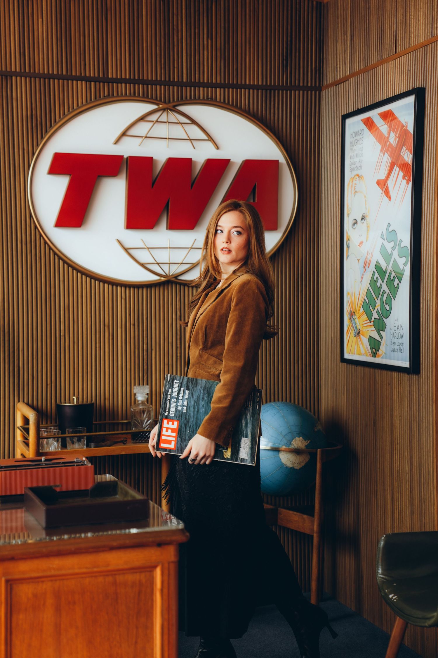 Retro TWA airline ticket counter display with wood paneling and vintage signage in warm lighting.