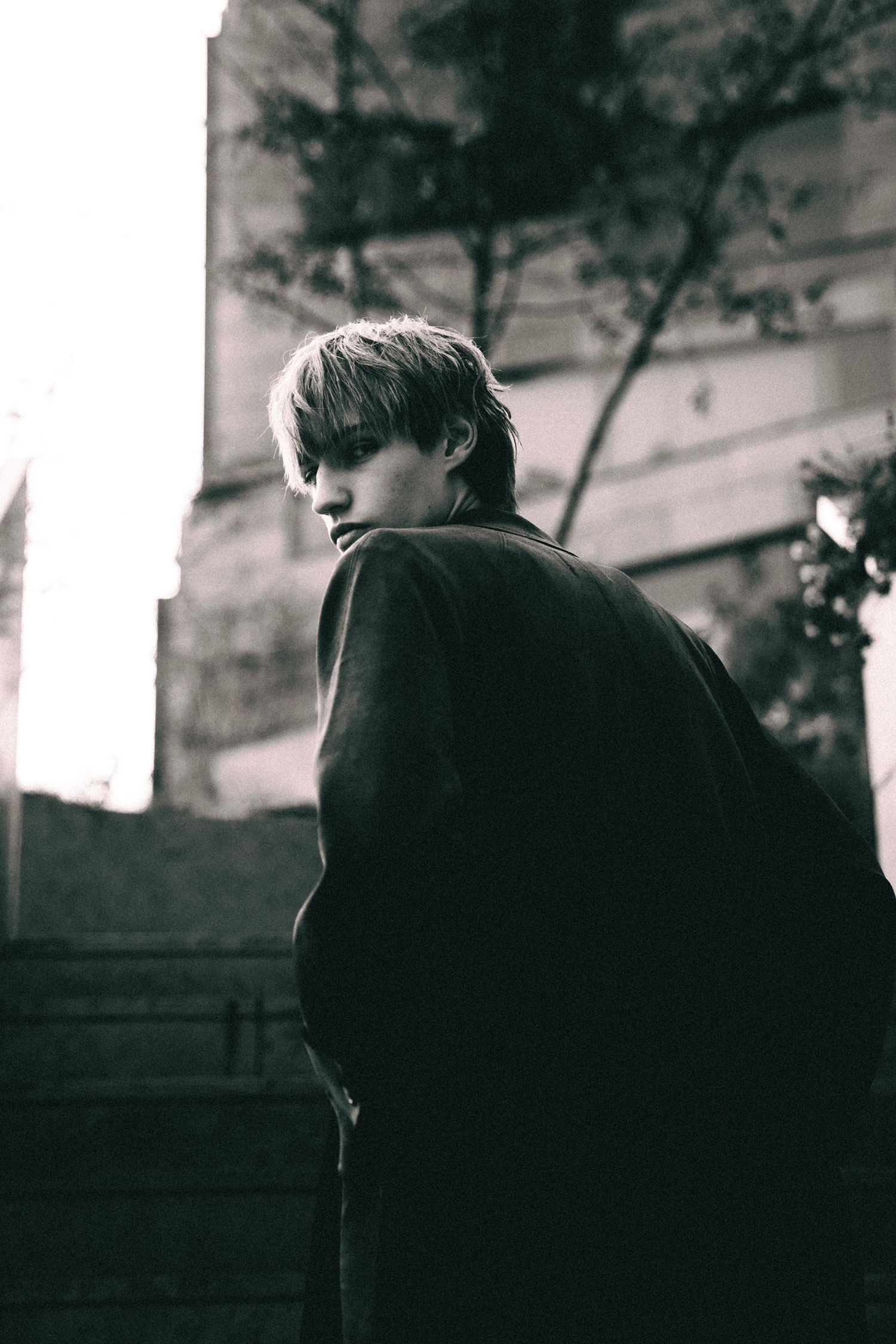 A black and white photo series shows a silhouette turning away in a dramatic sequence of motion.