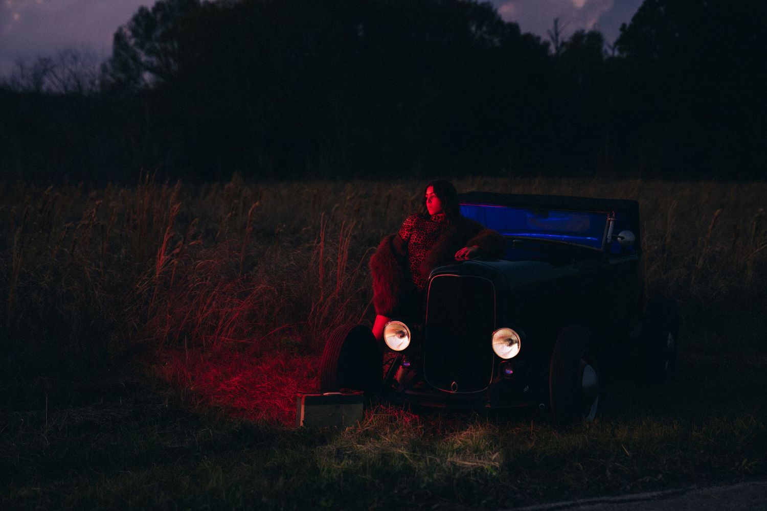 A series of dark, moody landscape photographs with red illuminated elements at night create an eerie atmosphere.