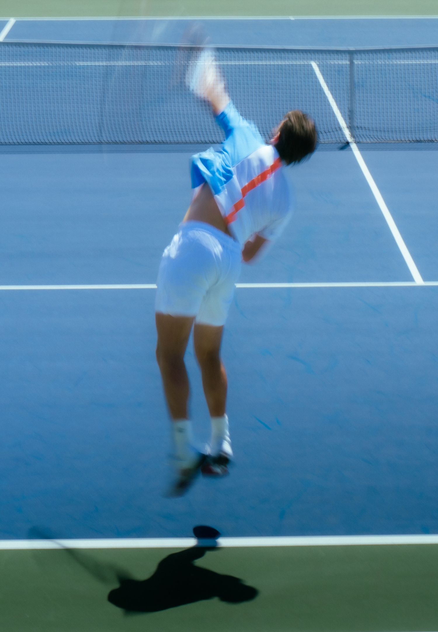 A sequence showing a tennis player slipping and falling on a blue hard court during a match.