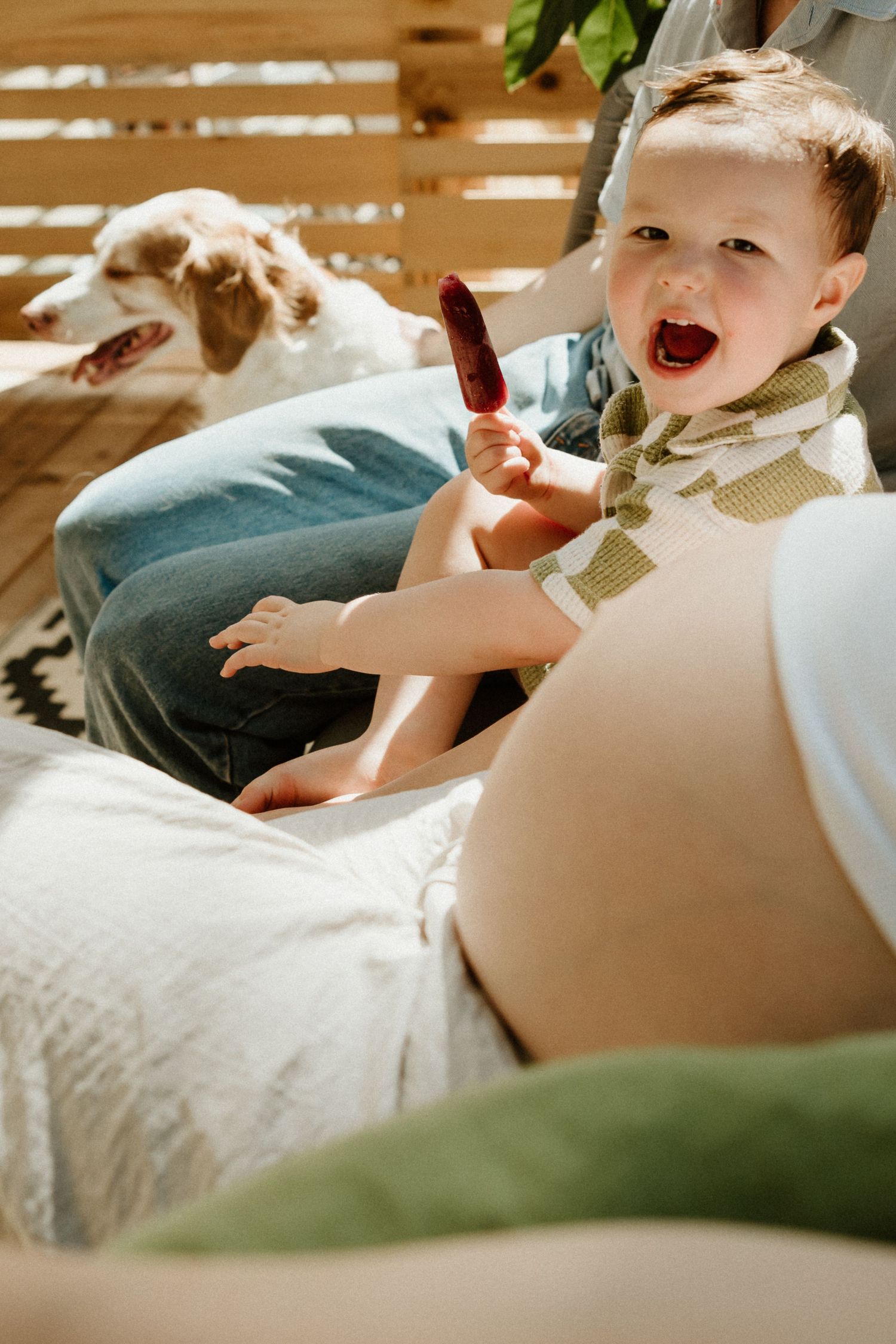 A sequence of candid moments showing a child laughing and playing on a couch with soft lighting.