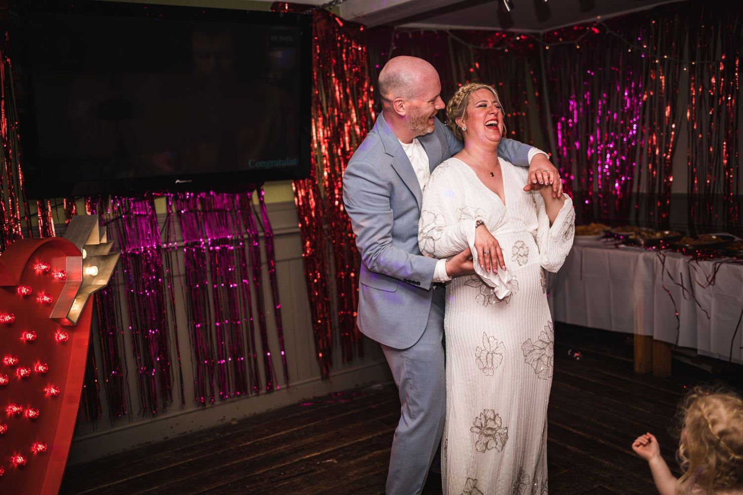 couple first dance laughing