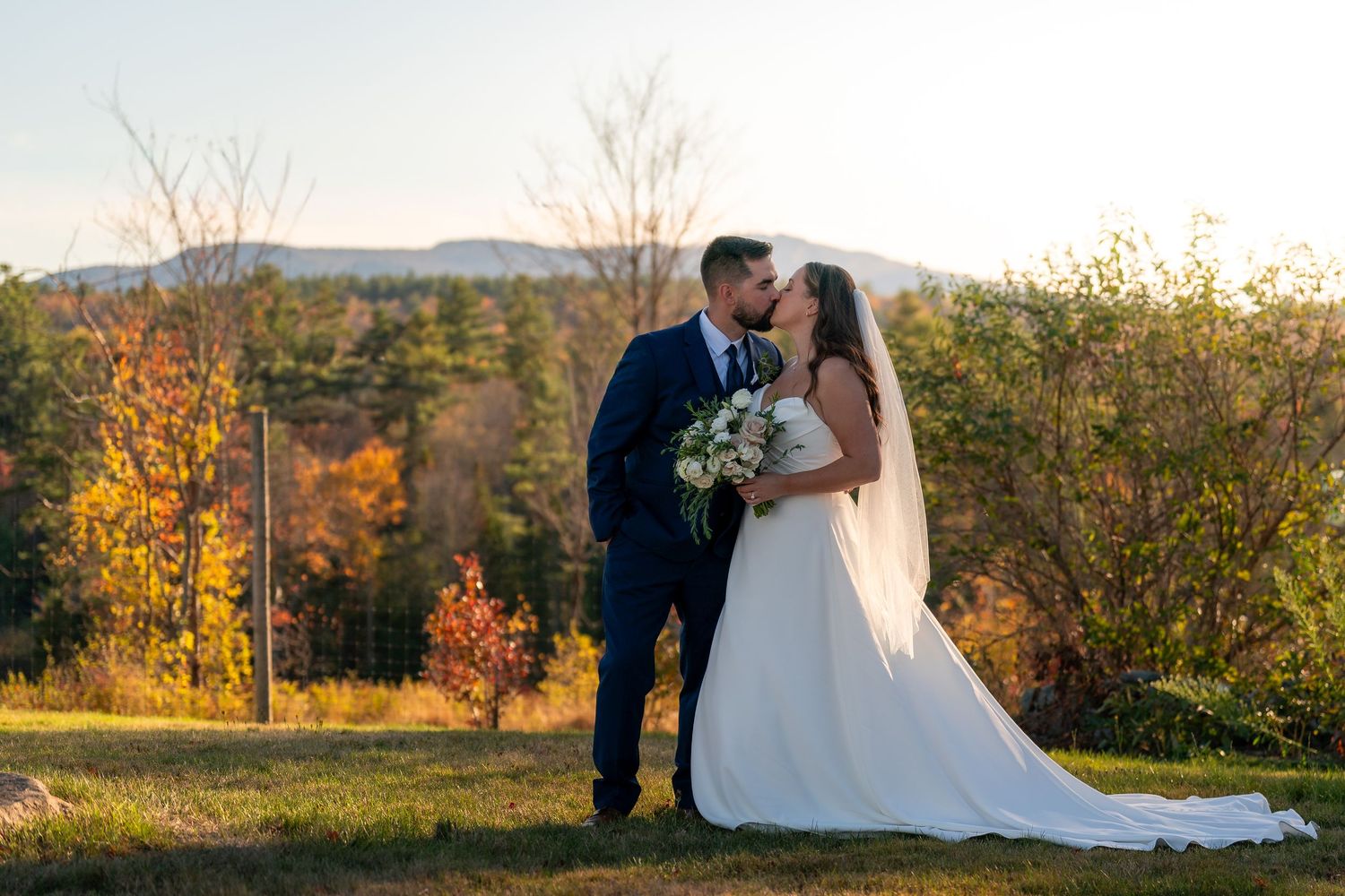 Photography bride and groom share intimate moment at sunset after an elegant New England barn wedding ceremony celebration in New Hampshire