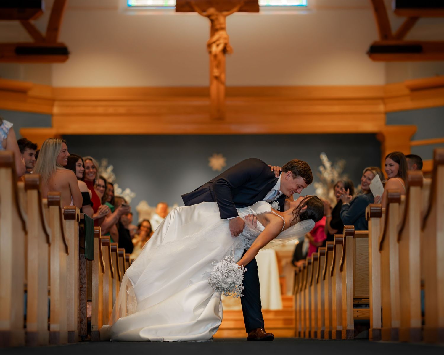 Photography of bride and groom sharing a moment with friends and family after an elegant New England church wedding ceremony New Hampshire.