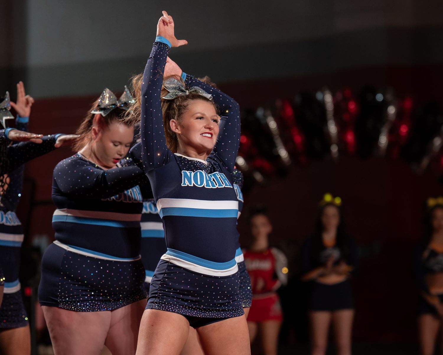 Fv3 Media Ambassador Riley Russell - Cheerleader Captain for Nashua North High School cheering as a base at a NHIAA spirit competition