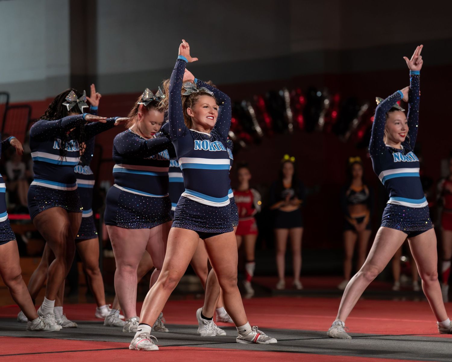 Fv3 Media Ambassador Riley Russell - Cheerleader Captain for Nashua North High School cheering as a base at a NHIAA spirit competition