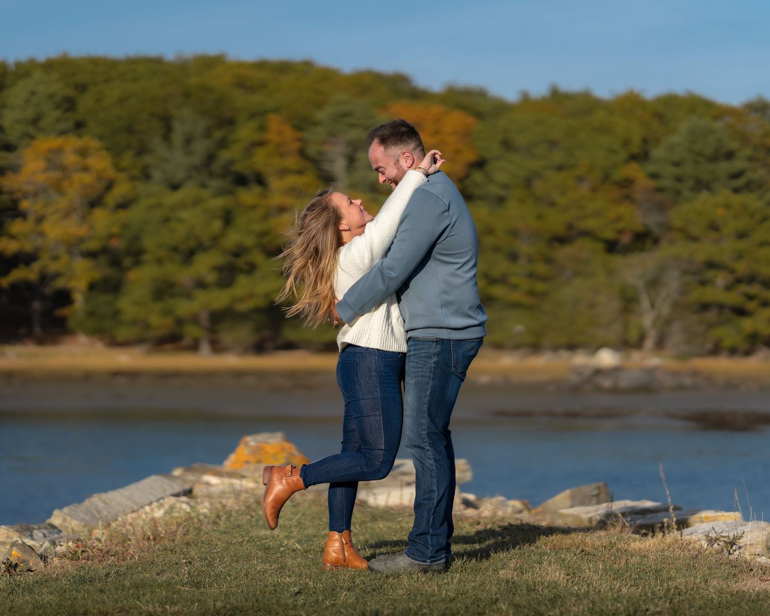 Photography of a engagement couple on a beautiful New England fall November day in New Hampshire by the ocean at golden hour.