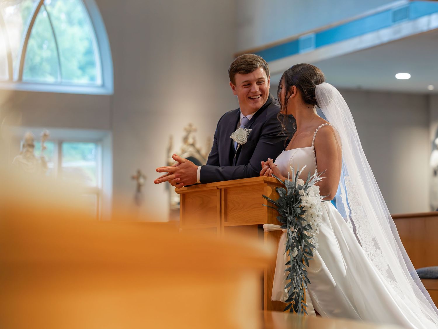 Photography of bride and groom sharing a moment with friends and family after an elegant New England church wedding ceremony New Hampshire.