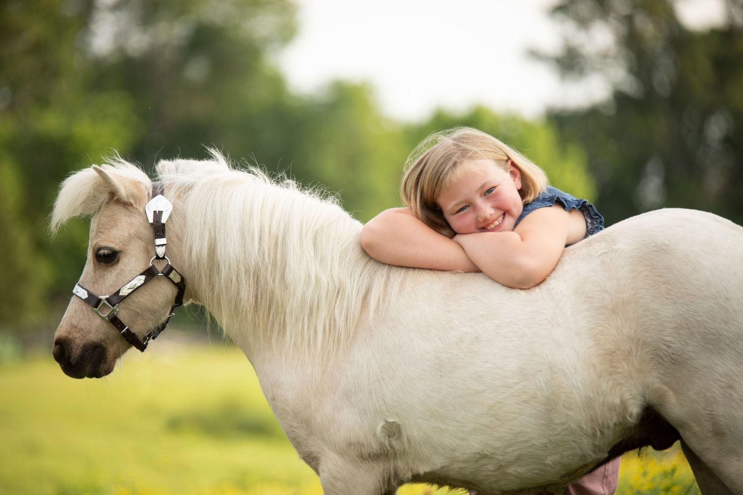 girl leaning over pony with arms crossed. Waco, Texas equine photographer.