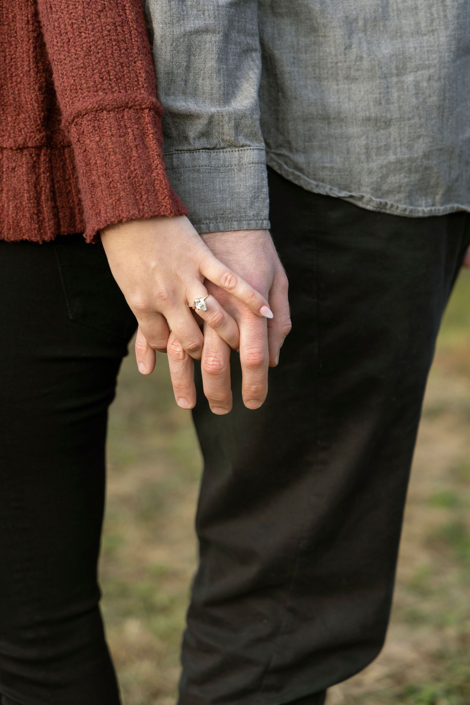 couple holding hands during an engagement session at a tree farm in Michigan
