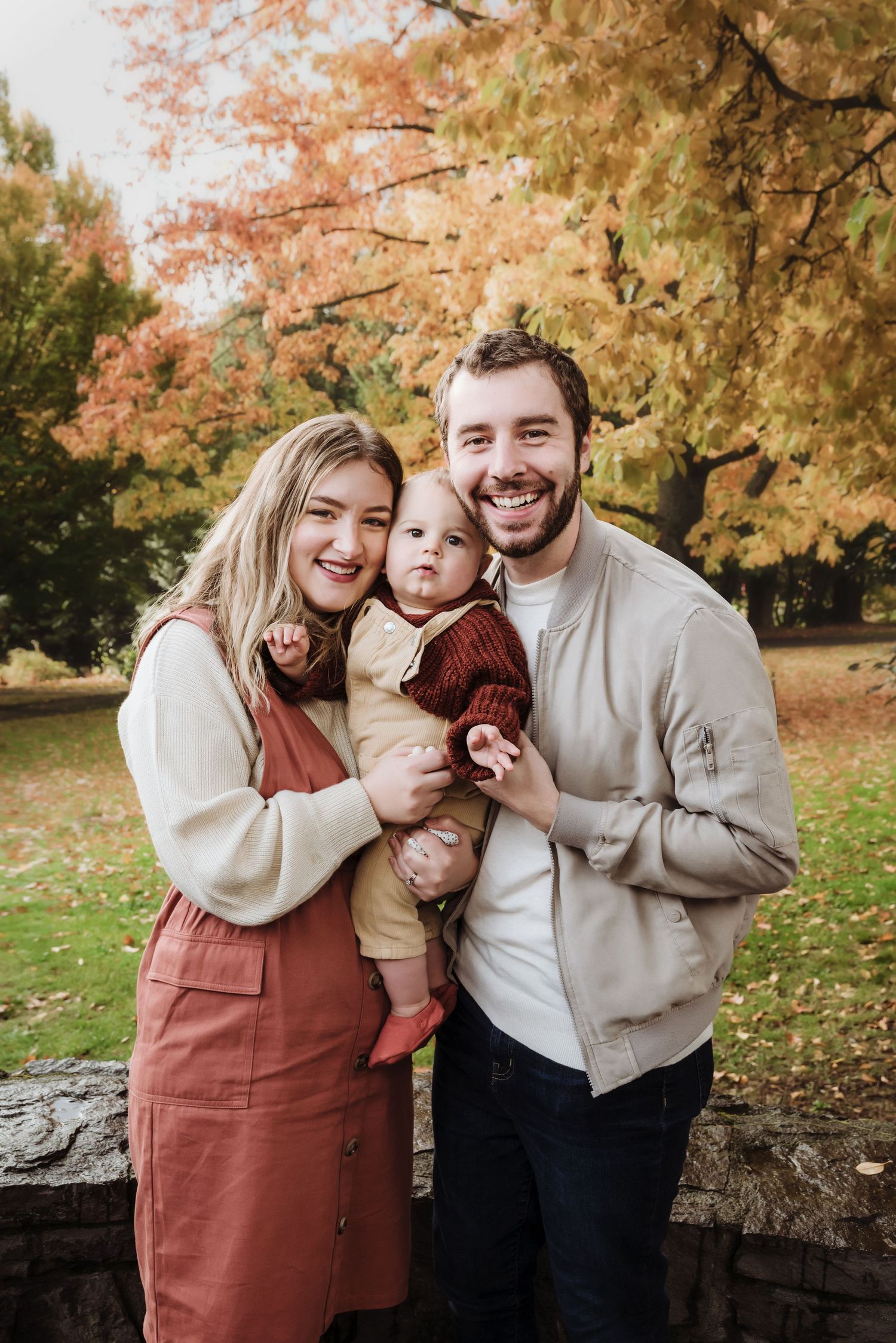 Family sharing joyful moments together among fall foliage.