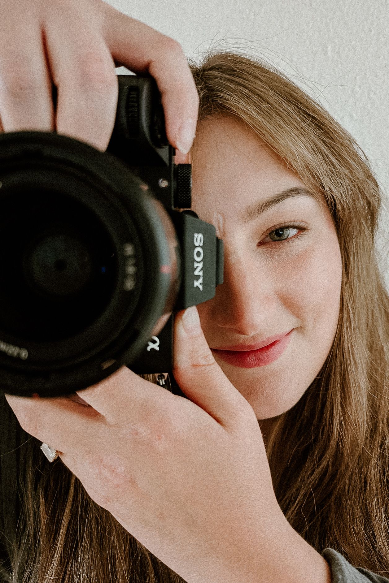 A close-up shot of someone taking a photo with a Sony camera.