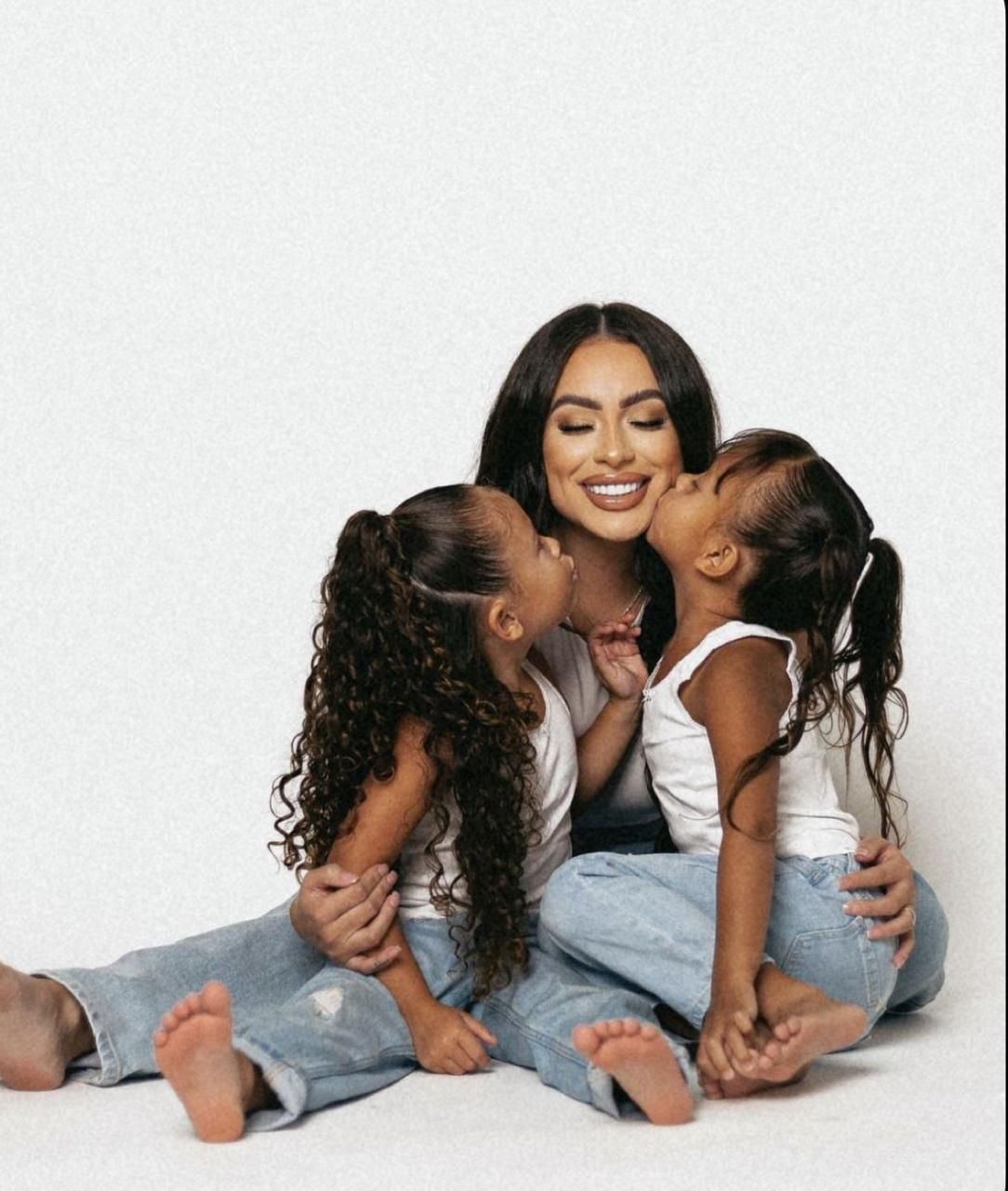 Four connected photos show people in casual white and gray clothing laying down and sharing joyful moments together.