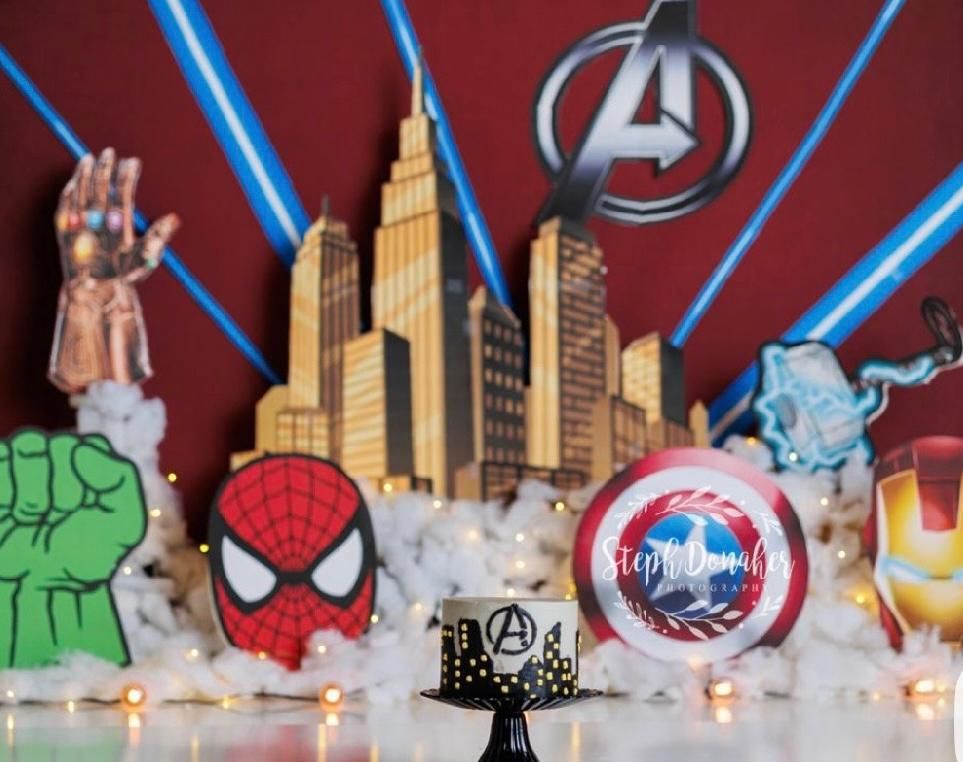 A colorful banner featuring Marvel superhero characters and city skyline silhouettes with blue lighting effects.
