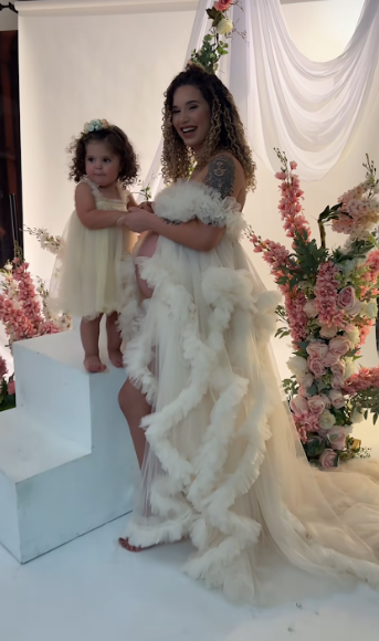 A series of photos showing a flowing white wedding gown with ruffles and pink floral decorations against a white backdrop.
