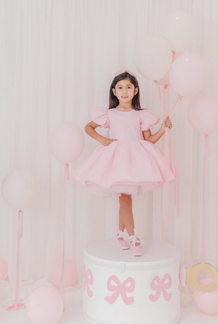 Pink and white studio setup with elegant decorative elements and soft lighting.