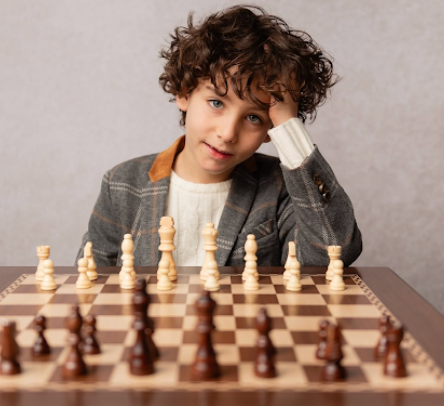 A person playing chess focuses intently on the board while contemplating their next strategic move.