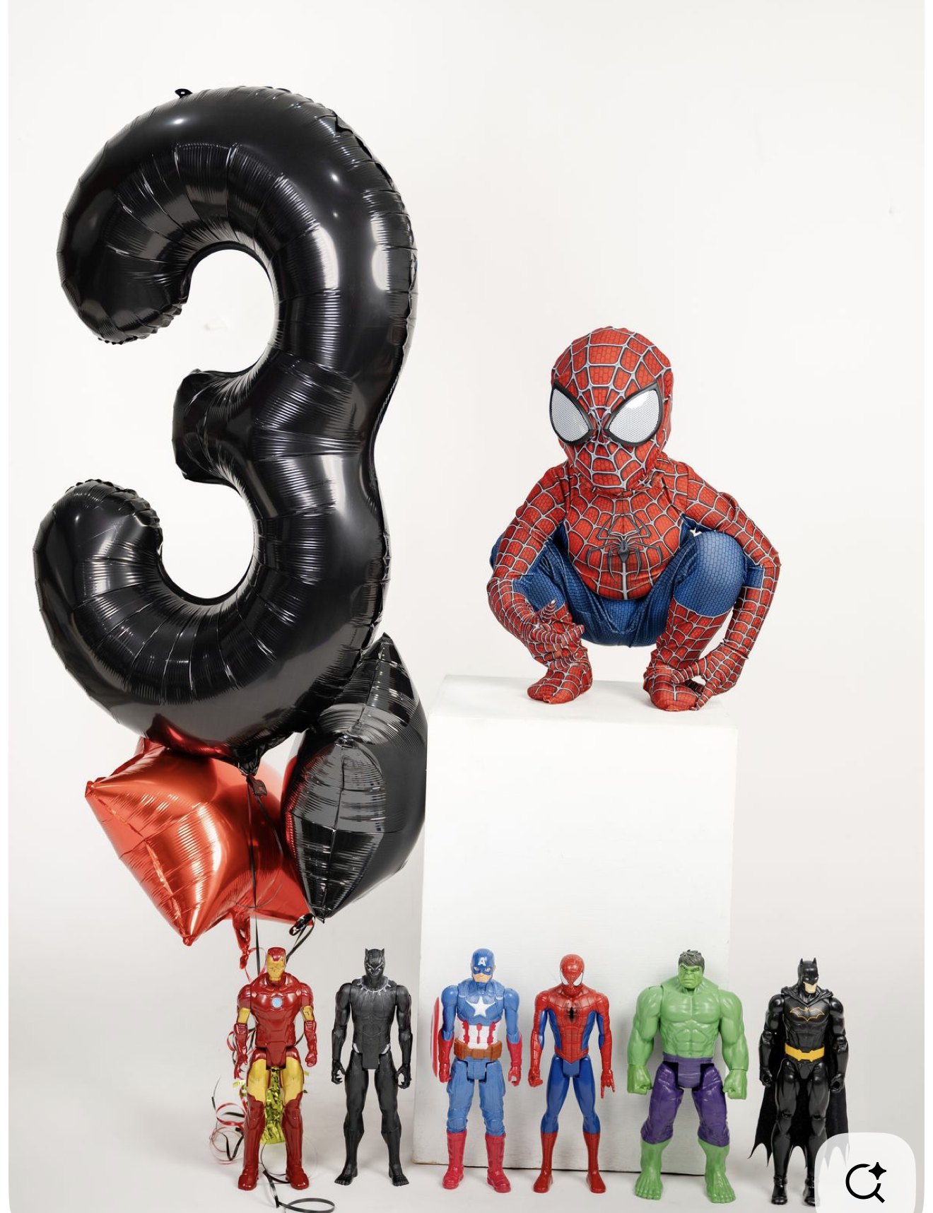 Superhero birthday party set with black number 3 balloon, Spider-Man figure, and Marvel action figures including Hulk and Iron Man.