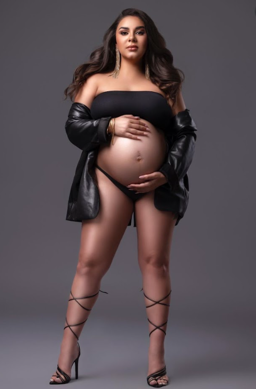 Professional maternity photoshoot featuring dark leather jacket and artistic poses against grey studio backdrop.