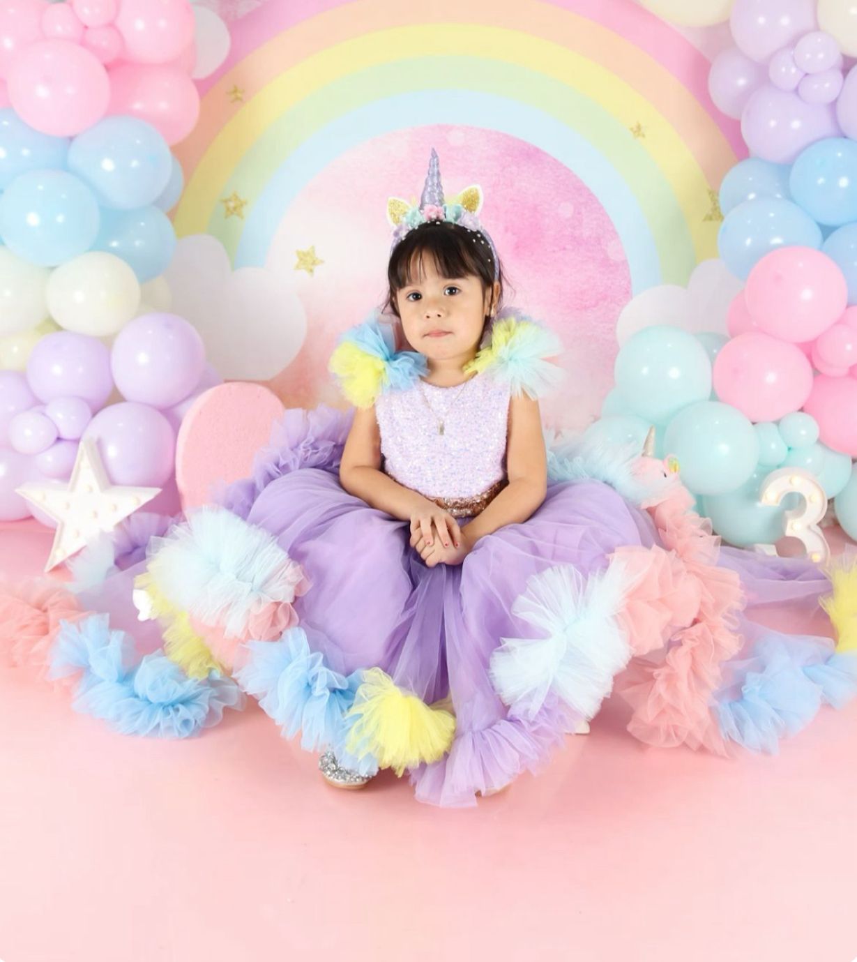 Dreamy pastel photography backdrop featuring soft pink, purple and blue pom poms and ethereal lighting effects.