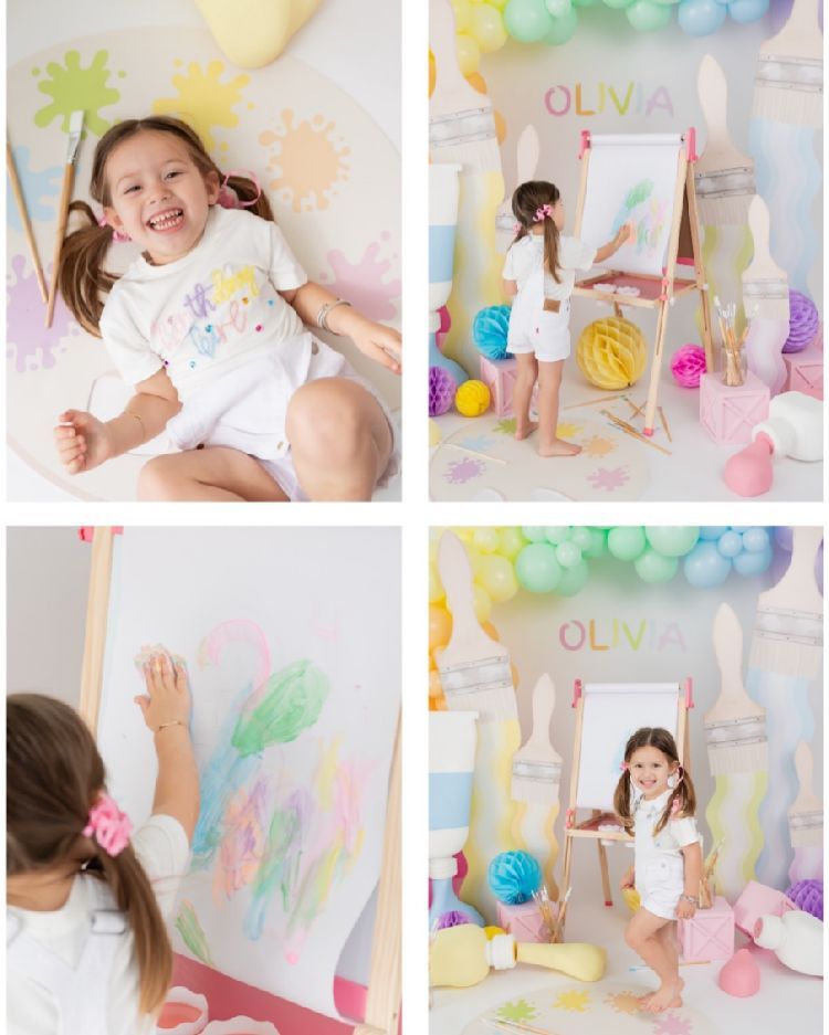 Pastel rainbow balloons and decorations create a dreamy birthday party setup with soft colors and whimsical details.