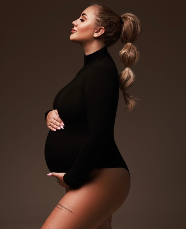 Elegant maternity portraits in black turtleneck against dark background showing profile poses.