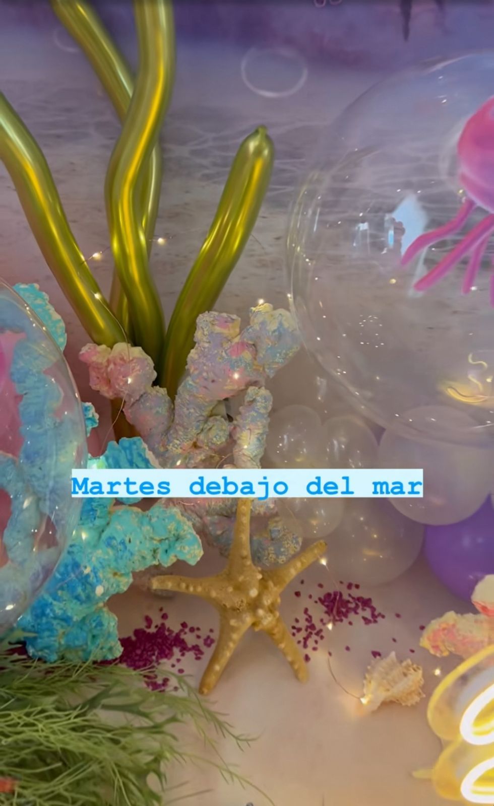 Underwater themed party decor with yellow seaweed, starfish, and blue coral elements.