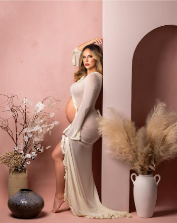A series of artistic maternity photos featuring white dresses and dried pampas grass against a soft pink backdrop.