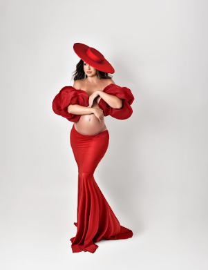 A series of fashion poses in a flowing red dress and matching hat against a white studio backdrop.