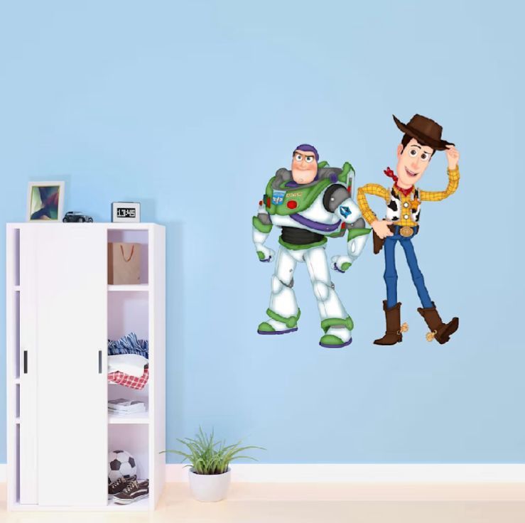 Minimalist blue wall decorated with Toy Story character cutouts and white accents.