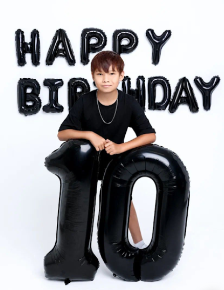 Black balloon letters spell 'HAPPY BIRTHDAY' above large black number '10' balloons against a white background.