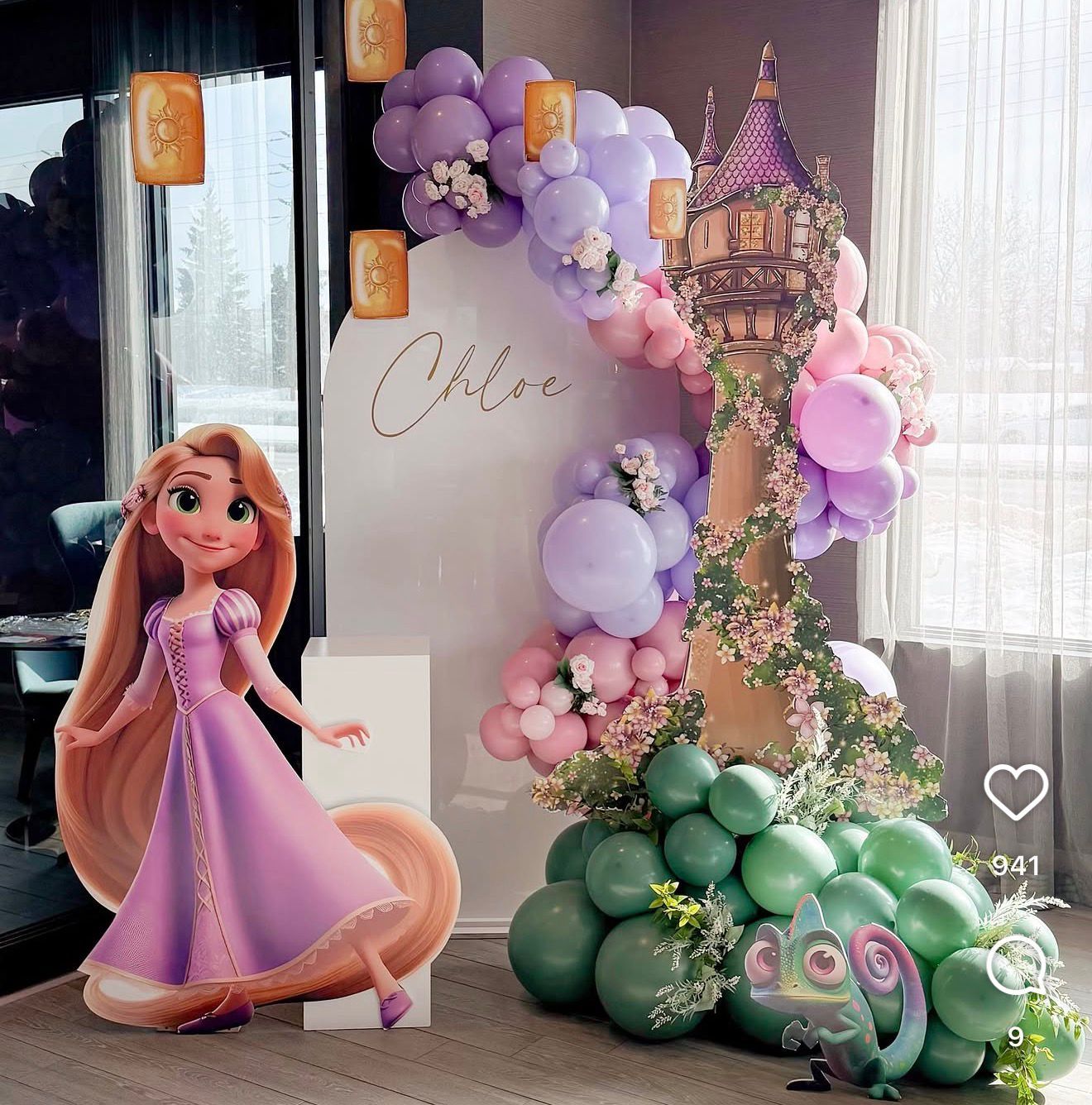 Rapunzel Tangled themed birthday party decor with balloon arch, castle tower, and Chloe name sign.
