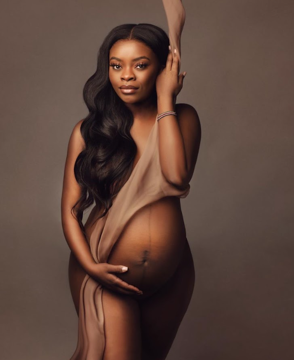 Artistic maternity photos showcase elegant poses against a brown studio backdrop.