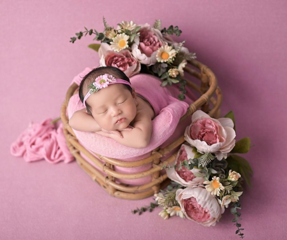 Newborn photography collage with pink floral arrangements and wooden props against soft pink backgrounds.