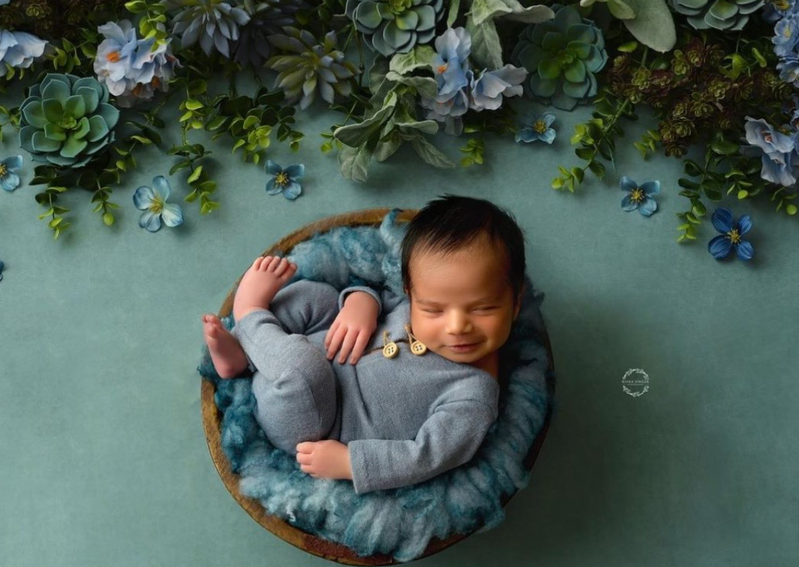 A series of photos showing someone in a blue-gray outfit lying on a teal colored surface in different poses.