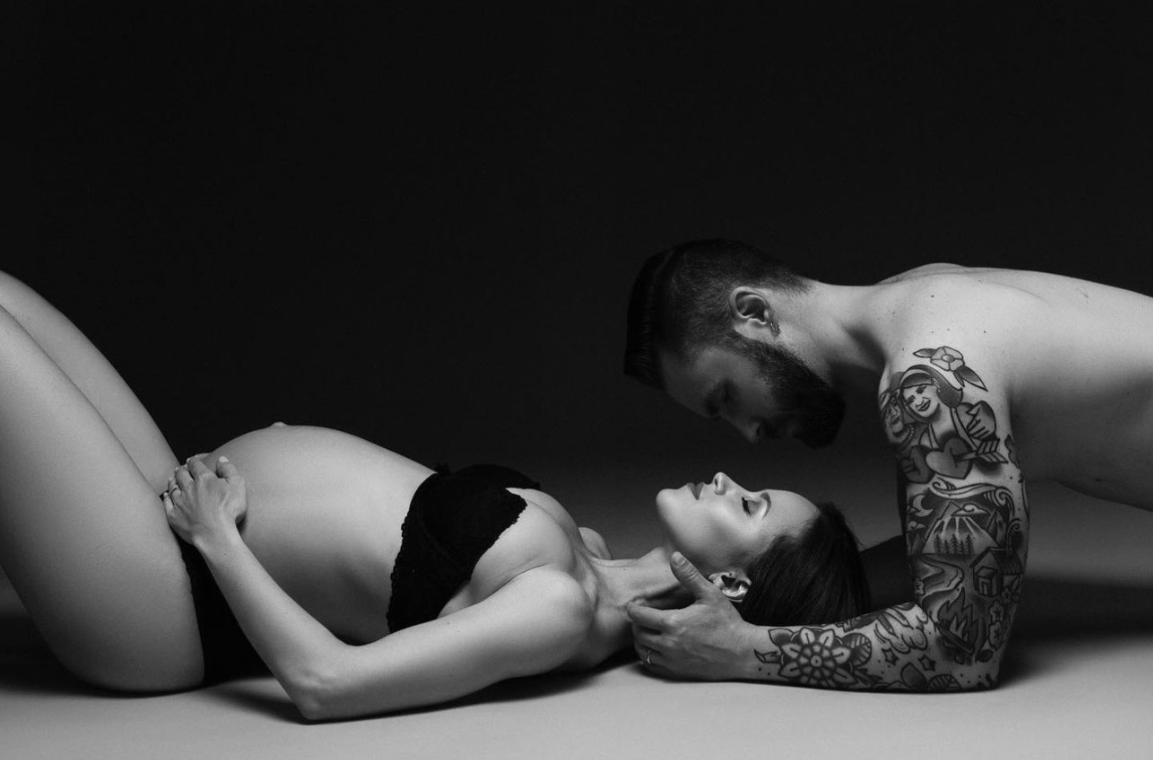 Dramatic black and white boudoir photography with soft lighting and silhouettes.