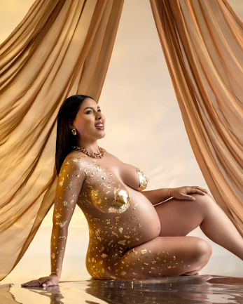 Artistic boudoir photo series with golden lighting and flowing fabric backdrop creating a sensual, glamorous mood.