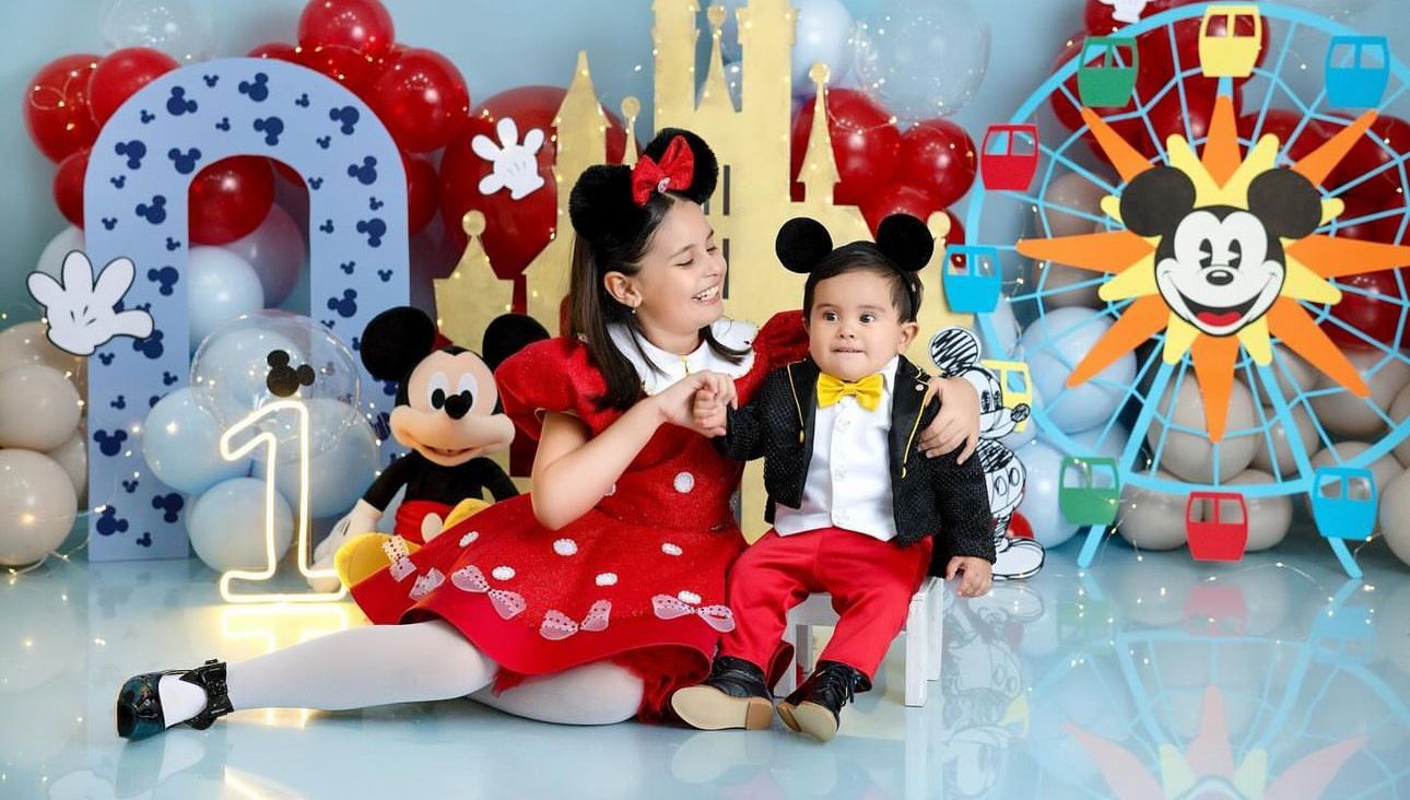 Collection of Disney themed plush toys and merchandise displays featuring Mickey Mouse, stuffed animals and colorful decor.