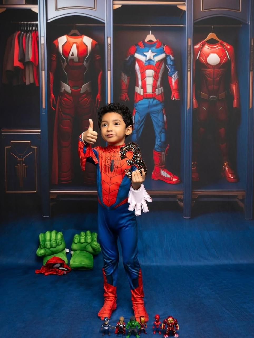A series of Spider-Man costumes displayed in illuminated cases against a dark blue background.